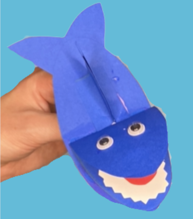 Blue shark hand puppet made of paper with googly eyes