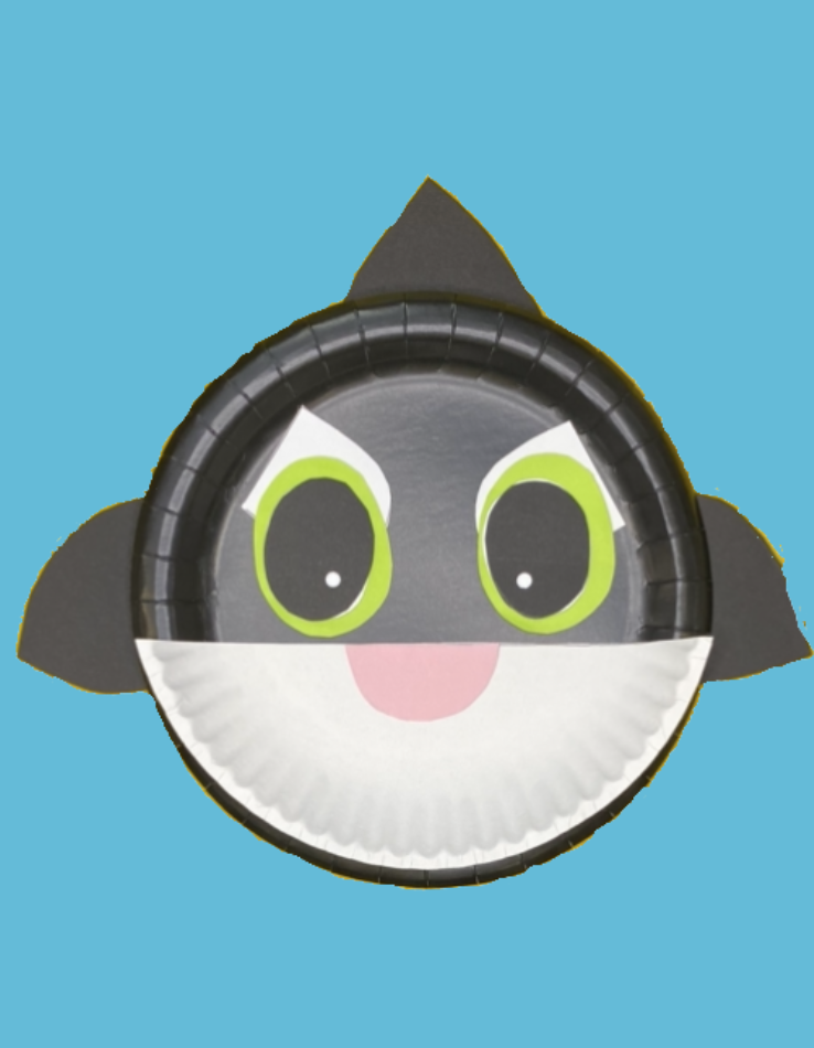 A black and white orca with a pink mouth and green eyes on a blue background