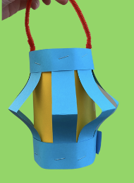Blue paper lantern with yellow center on green background