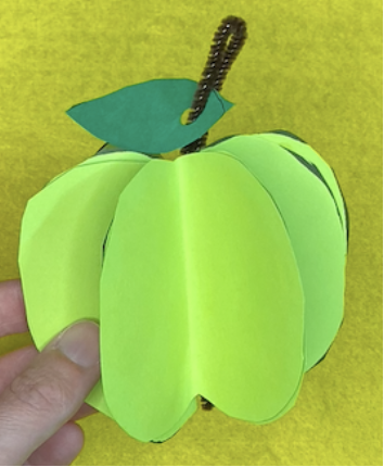 Paper light green apple on yellow background